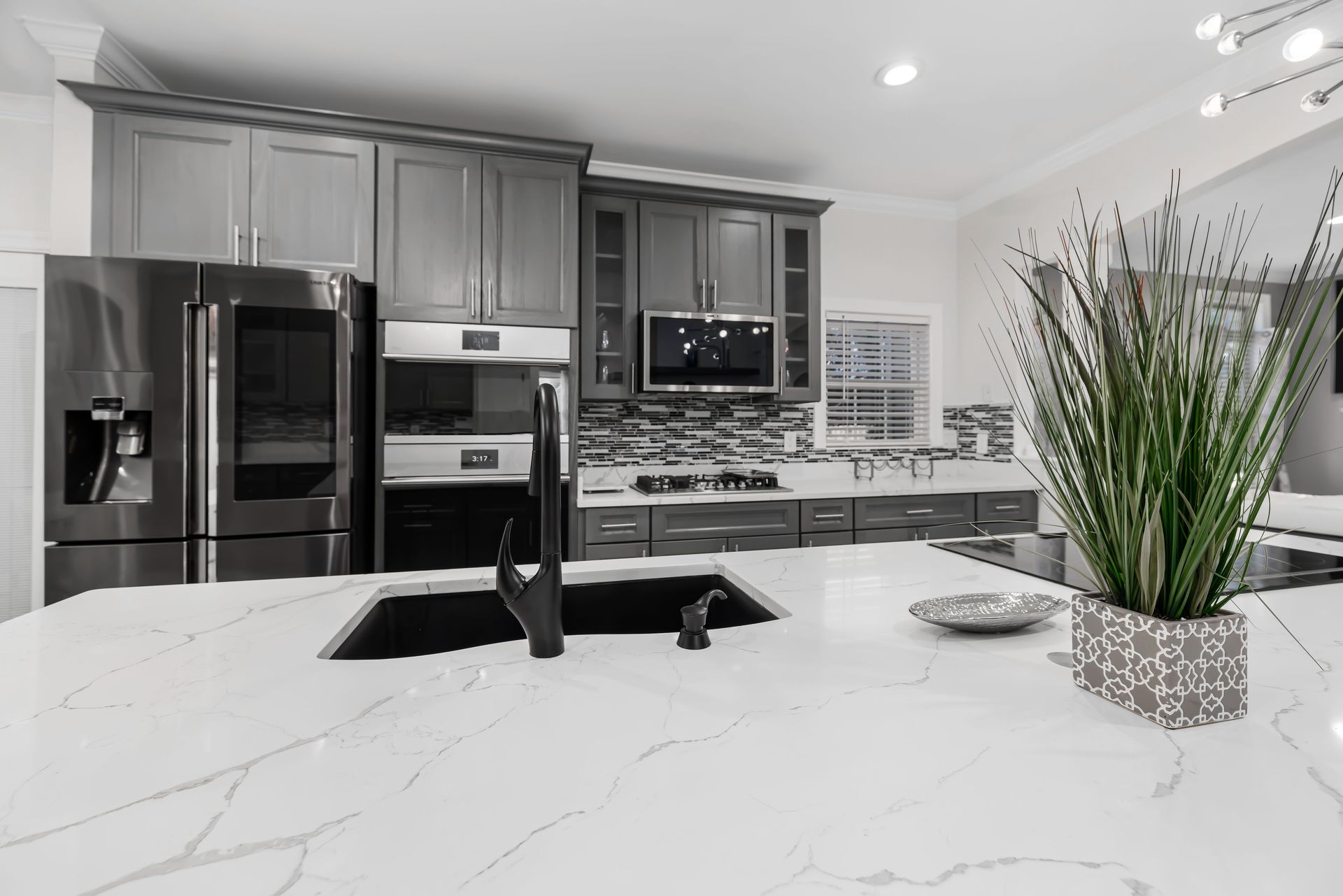 Sleek modern kitchen featuring marble countertops and elegant cabinetry.